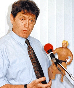 Consumer Product Safety Commission head David Arnell holds one of the hazardous, way-cool dolls.
